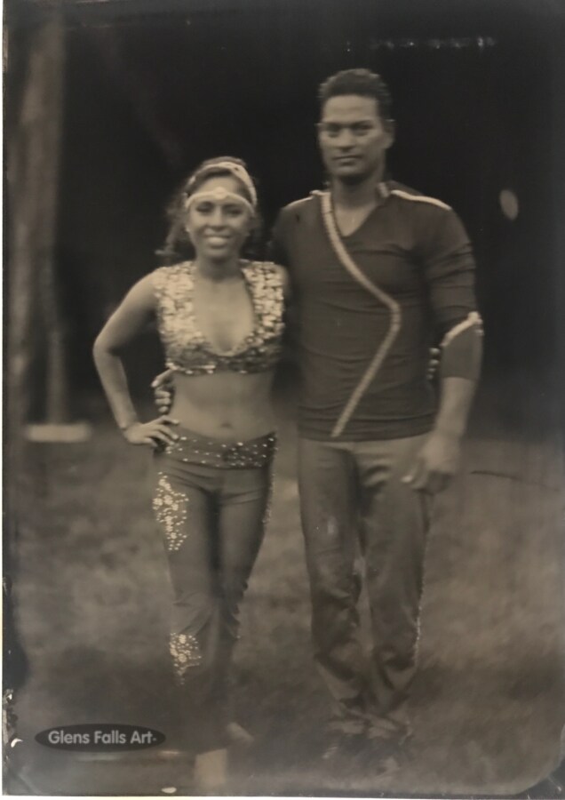 Tintype art by artist craig murphy of two zerbini circus performers standing with words glens falls art in oval logo